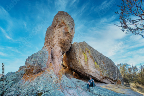 San Benito County and Monterey County, California, USA - October 10, 2020, a tourist near a large rock in Pinnacles National Park. Concept, active recreation in nature, tourism.