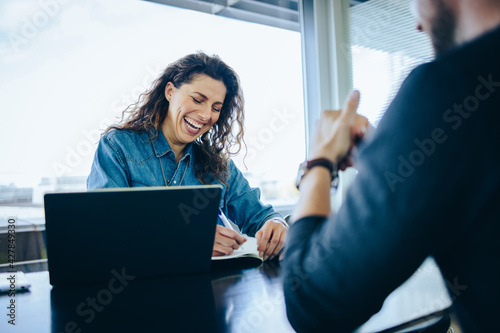 Employer interviewing job applicant and smiling