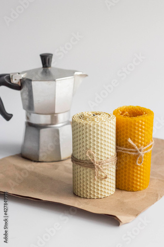 coffee pot and bee wax candles on paper