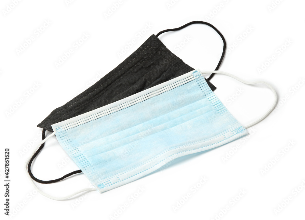 Black and white surgical face masks with rubber ear straps isolated on white background Black and white surgical face masks with rubber ear straps isolated on white background