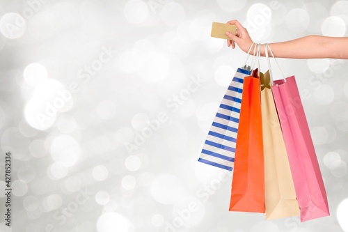 Woman hand with many shopping bags and credit card