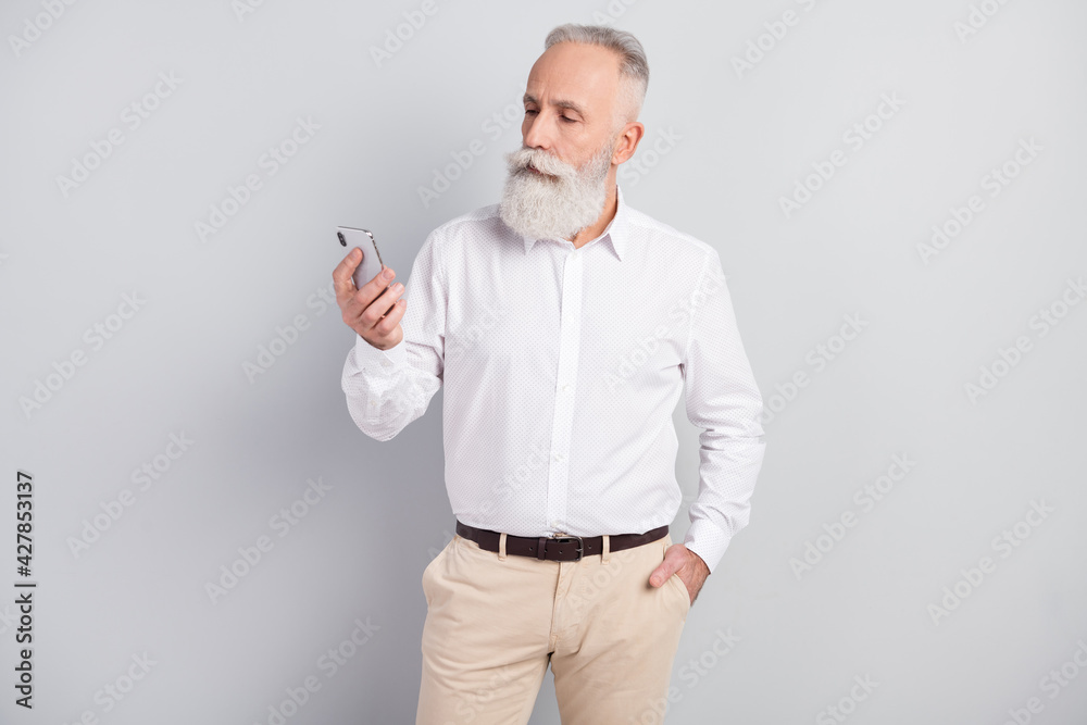 Profile photo of strict grey hair old man boss look telephone wear white shirt isolated on grey color background Profile photo of strict grey hair old man boss look telephone wear white shirt isolated on grey color background
