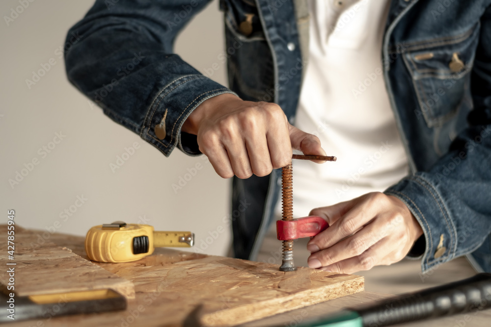 Male carpenter builder working with wooden board in the workshop to decorate the woodwork. Male carpenter builder working with wooden board in the workshop to decorate the woodwork.