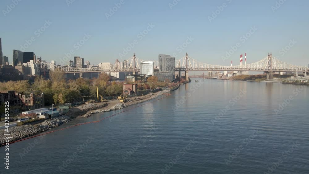 Fly over East River towards Ed Koch Queensboro Bridge. Ravenswood Generating Station on background Fly over East River towards Ed Koch Queensboro Bridge. Ravenswood Generating Station on background