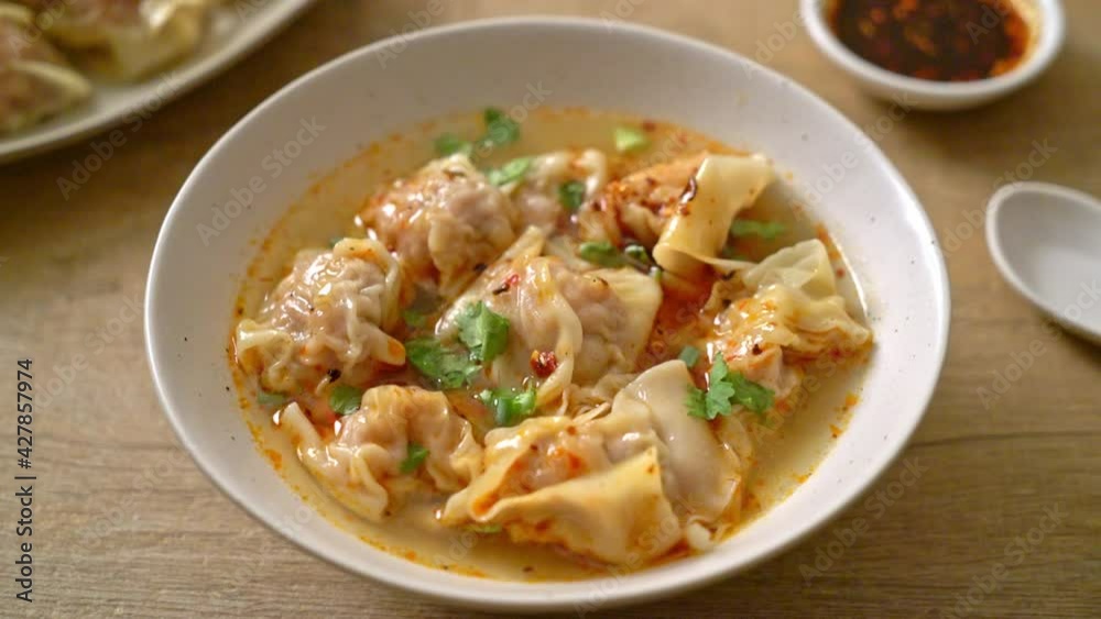 pork wonton soup or pork dumplings soup with roasted chili - Asian food style pork wonton soup or pork dumplings soup with roasted chili - Asian food style