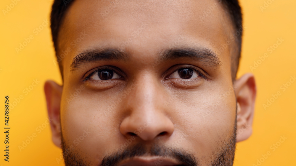 Close up portrait of young indian man with mustache isolated on yellow background. High quality photo Close up portrait of young indian man with mustache isolated on yellow background. High quality photo
