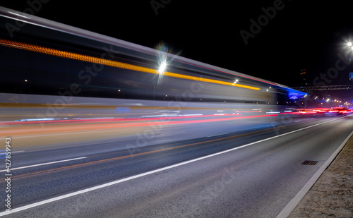 Long exposure shot of a busy street at night creating dynamic effect of the vehicle lights.