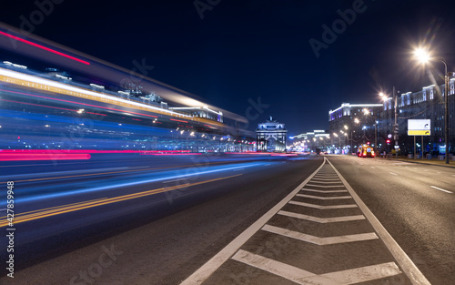 Long exposure shot of a busy street at night creating dynamic effect of the vehicle lights. © kurtov