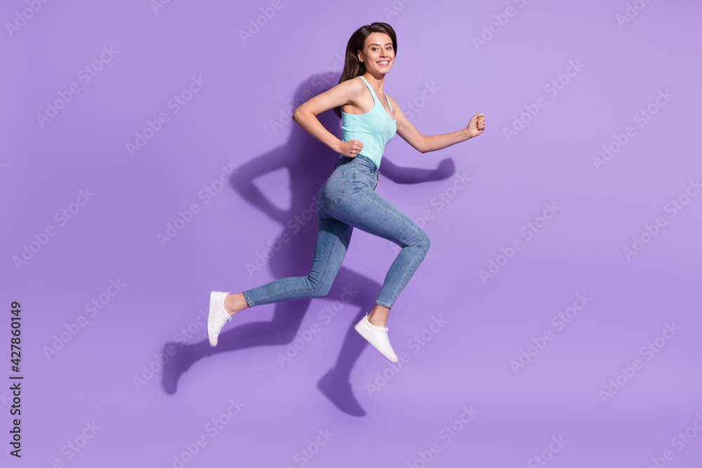 Full size profile side photo of young happy dreamy young woman jump up run empty space isolated on violet color background