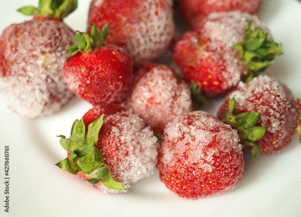 Frozen fruits and berries. Pieces of ice on strawberries. Frozen fruits and berries. Pieces of ice on strawberries.