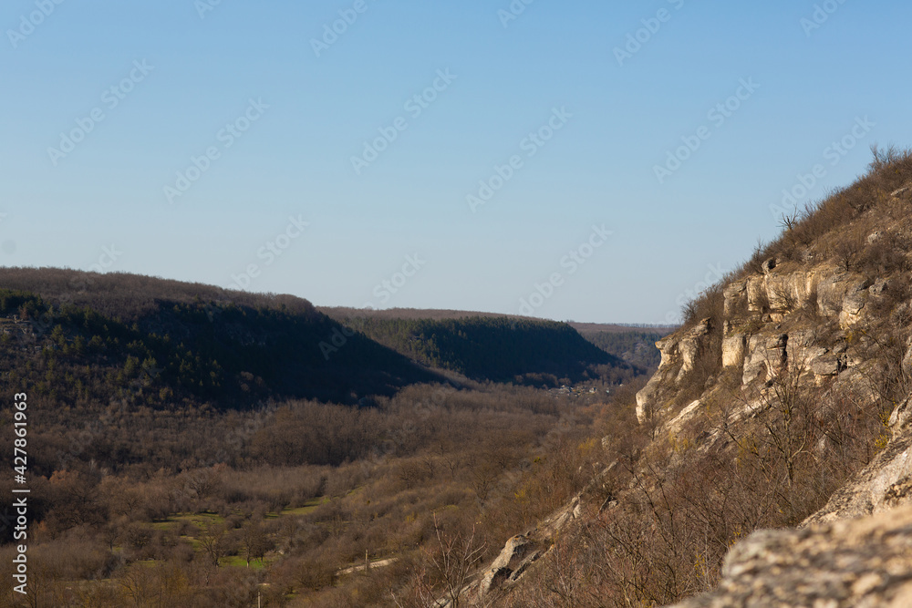 Colourful landscape with high mountains, green pine forest and blue sky. Mountain valley.