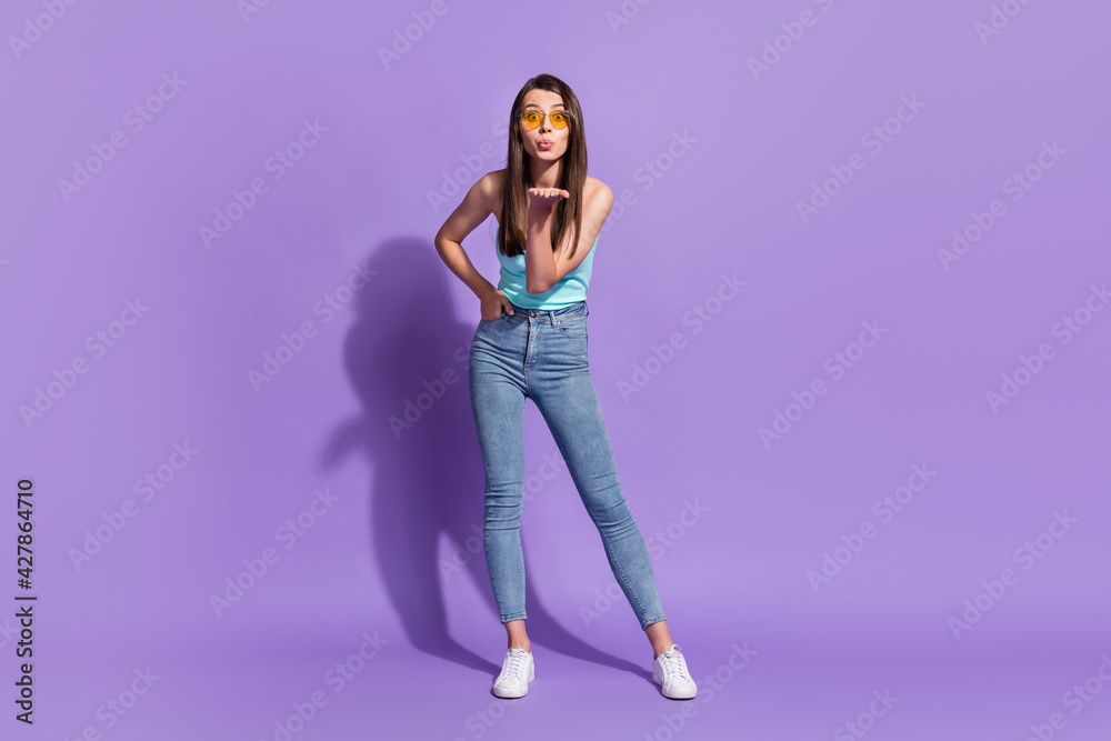 Full size photo of flirty young happy woman send air kiss young wear sunglass isolated on purple color background