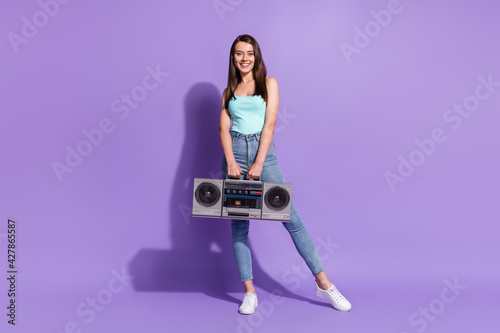 Full length photo of charming happy lady hold boom box music lover good mood isolated on purple color background