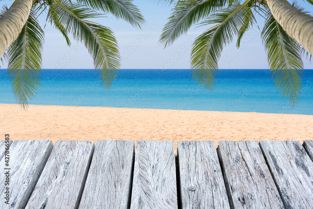 Wooden floor or plank on blurred background of the sea in summer. For product display.Calm Sea and Blue Sky Background.