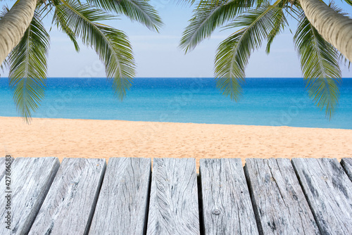 Fototapeta Naklejka Na Ścianę i Meble -  Wooden floor or plank on blurred background of the sea in summer. For product display.Calm Sea and Blue Sky Background.
