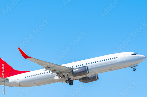 Passenger airplane flying against clear blue sky