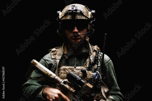 Fototapeta Special forces soldier with rifle on black background