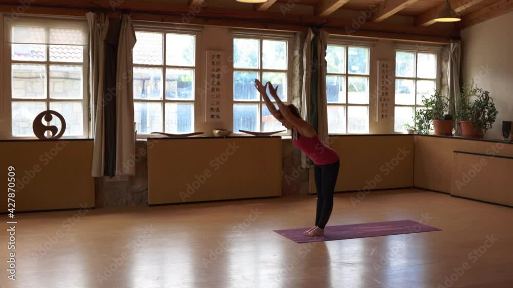 short-haired red-haired woman practicing yoga in her wood studio short-haired red-haired woman practicing yoga in her wood studio