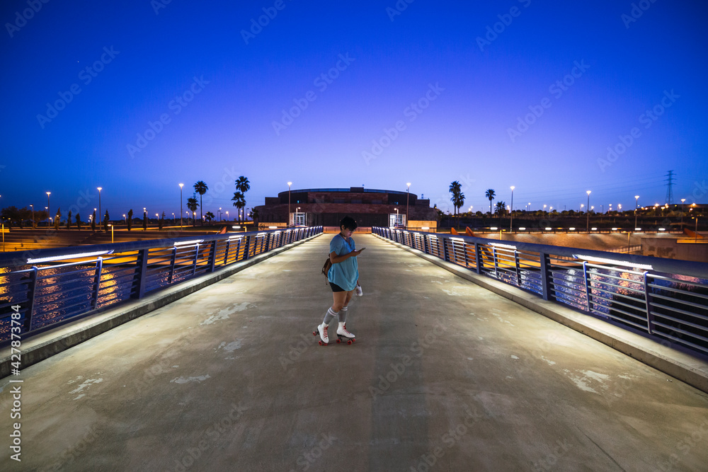 custom made wallpaper toronto digitalYoung Caucasian female wearing roller skates sitting on the road at night