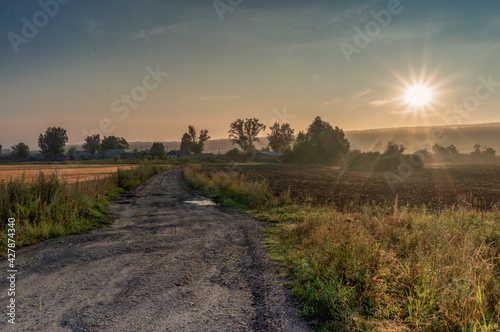 dirt road leading to the village and the field