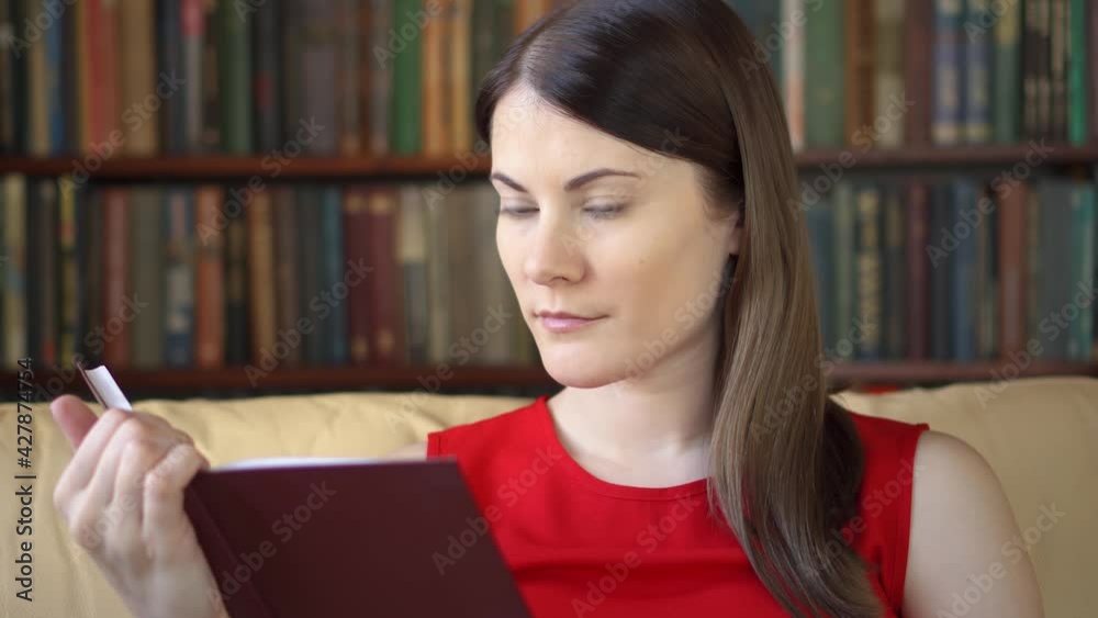 Young woman at home reading physical print book. Concept of old traditional classical paper reading Young woman at home reading physical print book. Concept of old traditional classical paper reading
