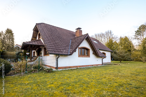 Large white country house in Germany or England. House with a beautiful garden. Holidays in the country. 