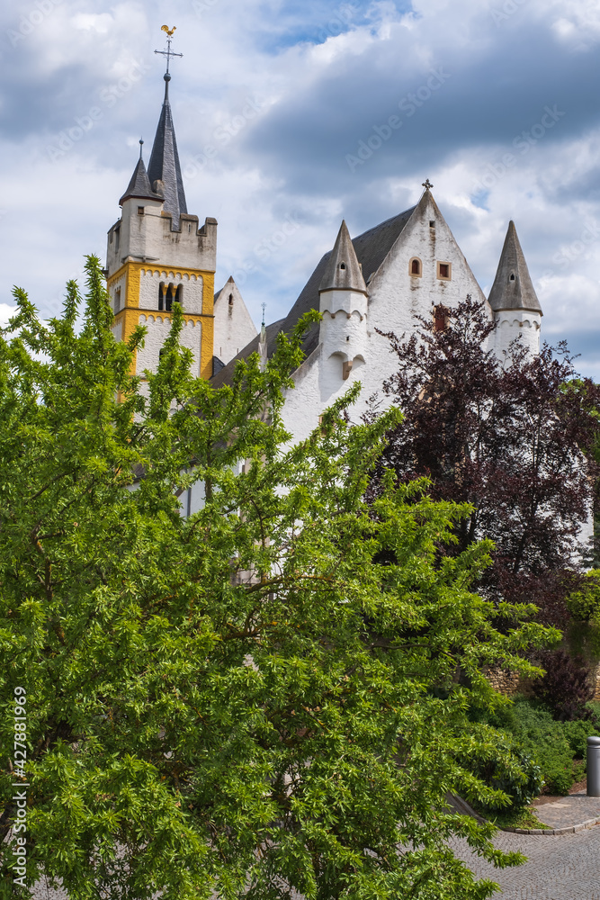 View of the castle church, partly covered by trees, in Ingelheim am Rhein / Germany View of the castle church, partly covered by trees, in Ingelheim am Rhein / Germany