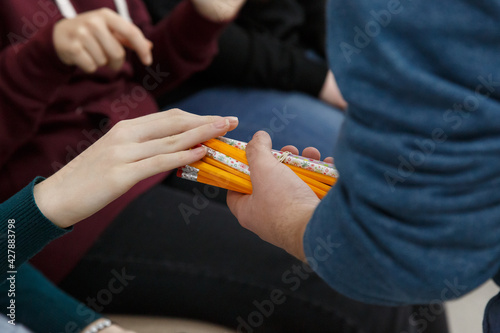 Hands passing pencils. Hands and a lot of pencils in a bunch. Playing with pencils.