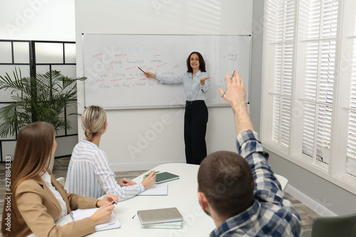 Obraz na plátně English teacher giving lesson near whiteboard in classroom