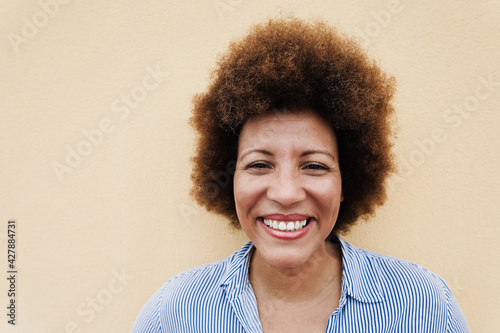 Happy african senior woman smiling on camera outdoor - Focus on face photo