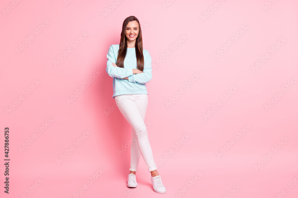 Full body photo of attractive sweet young woman crossed arms charming smile isolated on pastel pink color background Full body photo of attractive sweet young woman crossed arms charming smile isolated on pastel pink color background