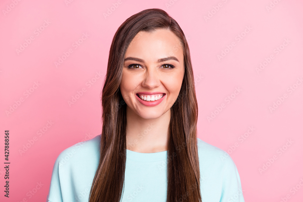 Photo of cheerful attractive young woman beaming smile long hair isolated on pastel pink color background Photo of cheerful attractive young woman beaming smile long hair isolated on pastel pink color background