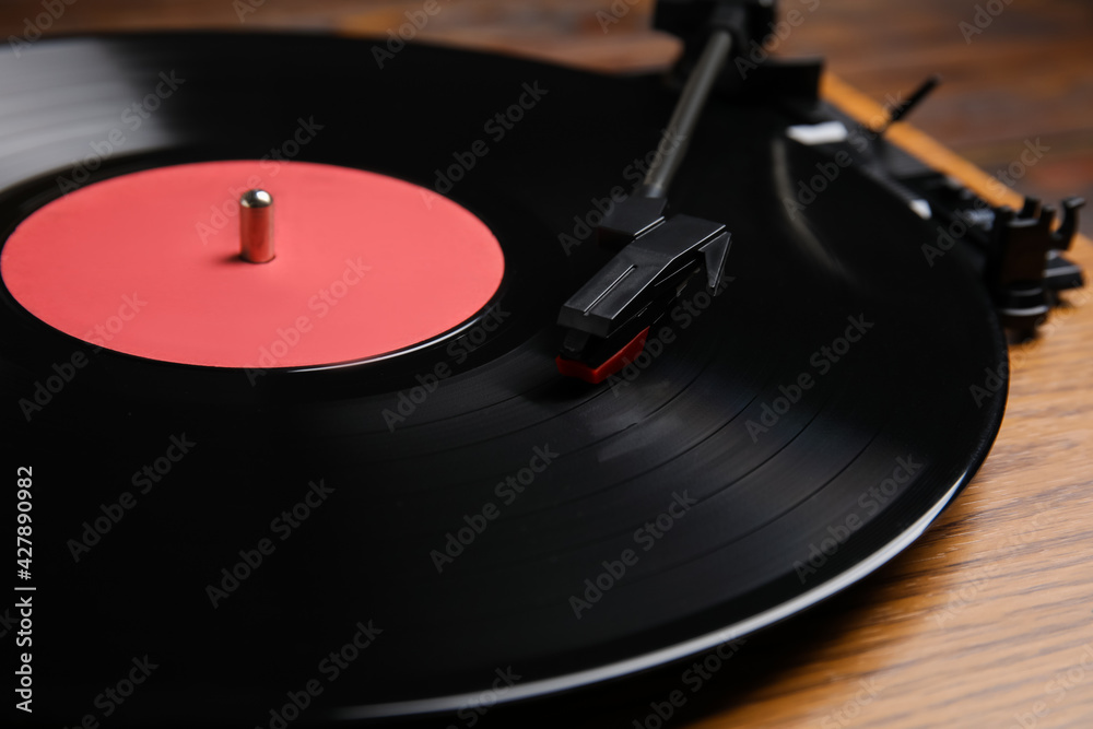 Modern vinyl record player with disc on table, closeup Modern vinyl record player with disc on table, closeup