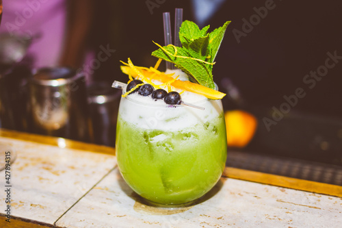 Fancy green cocktail drink at bar