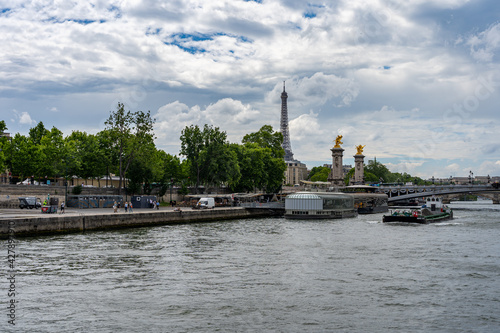 The Seine river and Eiffel Tower under summer blue sky