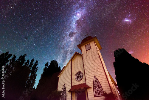 Vászonkép Little chapel in shores at Llanquihue lake against a starry sky with the milky w