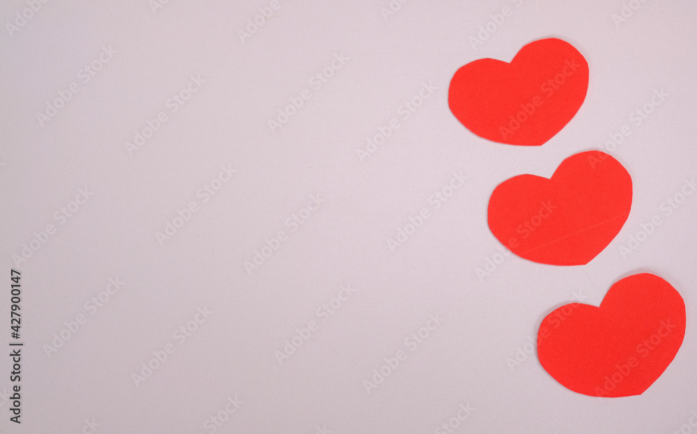 The red paper cut in the shape of a heart placed on a white background.