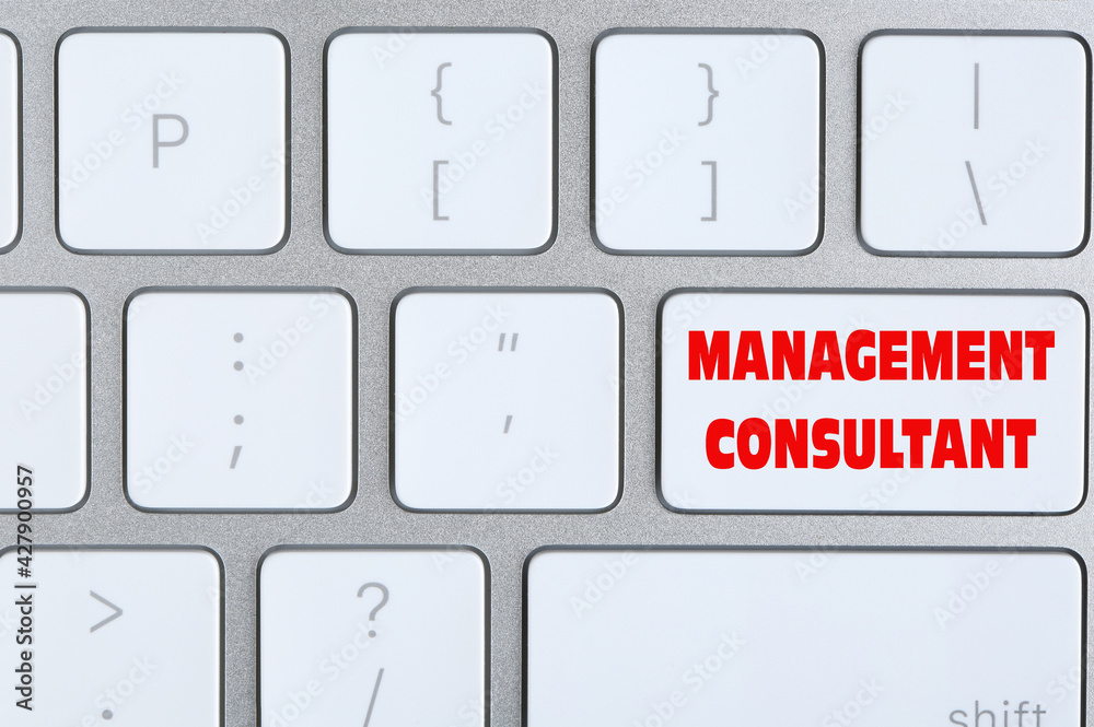 Button with text MANAGEMENT CONSULTANT on keyboard, top view