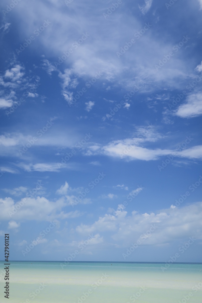 Ocean horizon idyllic scene, blue sky with some fluffy white clouds and turquoise water arranging a relaxed atmosphere, perfect wallpaper to dream Ocean horizon idyllic scene, blue sky with some fluffy white clouds and turquoise water arranging a relaxed atmosphere, perfect wallpaper to dream
