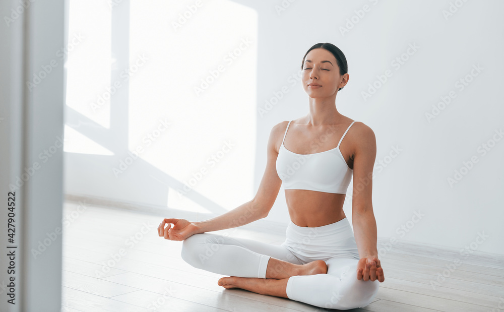 Lying down on the yoga mat. Young caucasian woman with slim body shape is  indoors at daytime 15363282 Stock Photo at Vecteezy