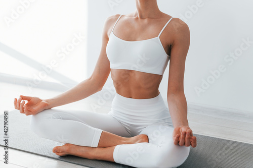 Young caucasian woman with slim body shape is indoors at daytime