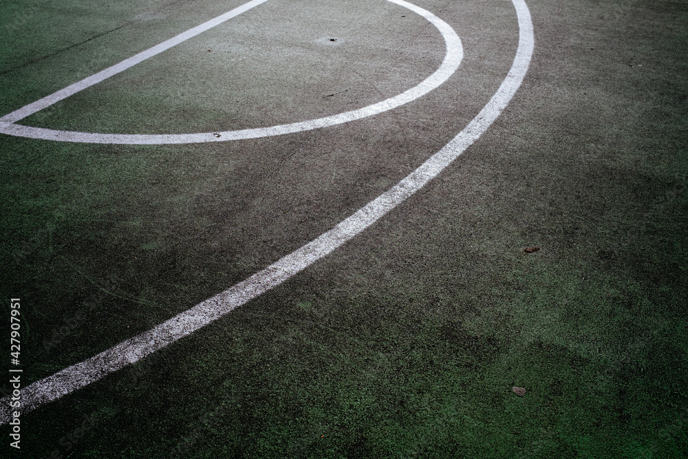 white lines on green basketball court