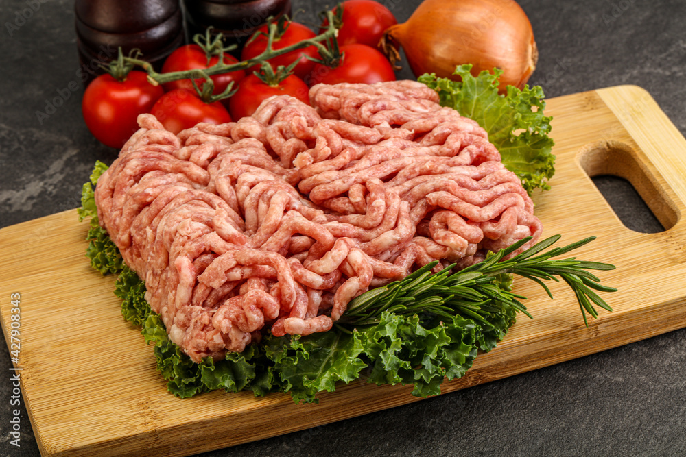 Raw pork minced meat over board Raw pork minced meat over board