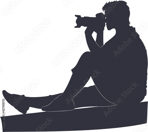 Silhouette of a woman photographer with a camera in her hands.