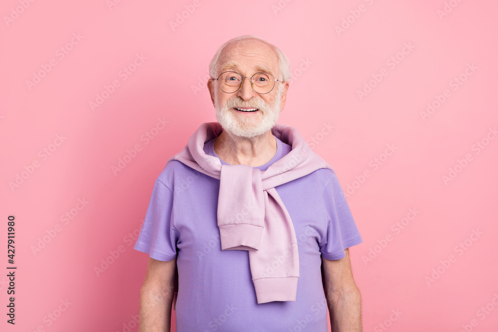Photo portrait of elder man in glasses smiling isolated on pastel pink color background Photo portrait of elder man in glasses smiling isolated on pastel pink color background