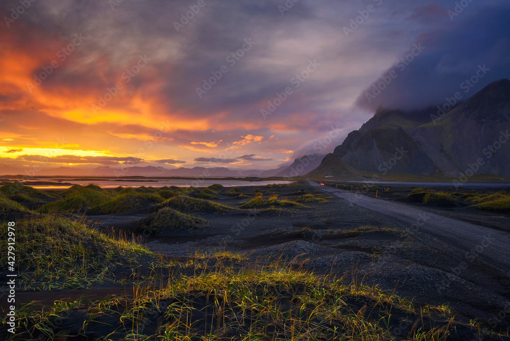 Gravel road at sunset with Vestrahorn mountain in the background, Iceland
