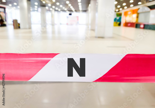 The letter N on the fastened tape. Concept letter on red and white ribbon