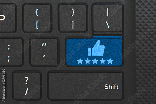 Rating icon on keyboard key. Conceptual idea of 5 star rating and truthness photo