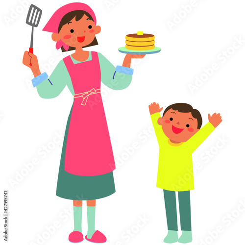パンケーキを焼く母親と喜ぶ子ども