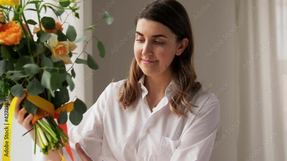 people, gardening and floral design concept - happy woman arranging flowers in vase at home people, gardening and floral design concept - happy woman arranging flowers in vase at home